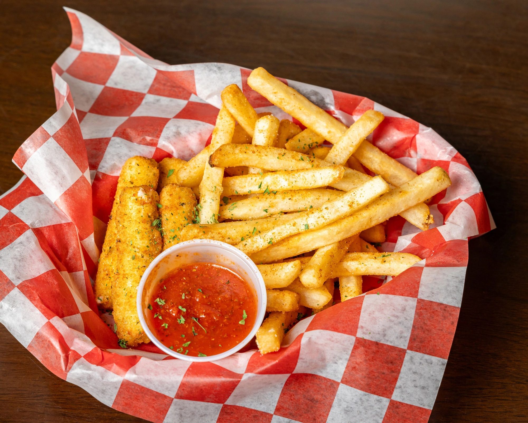Trap Sticks and fries in a checkered basket